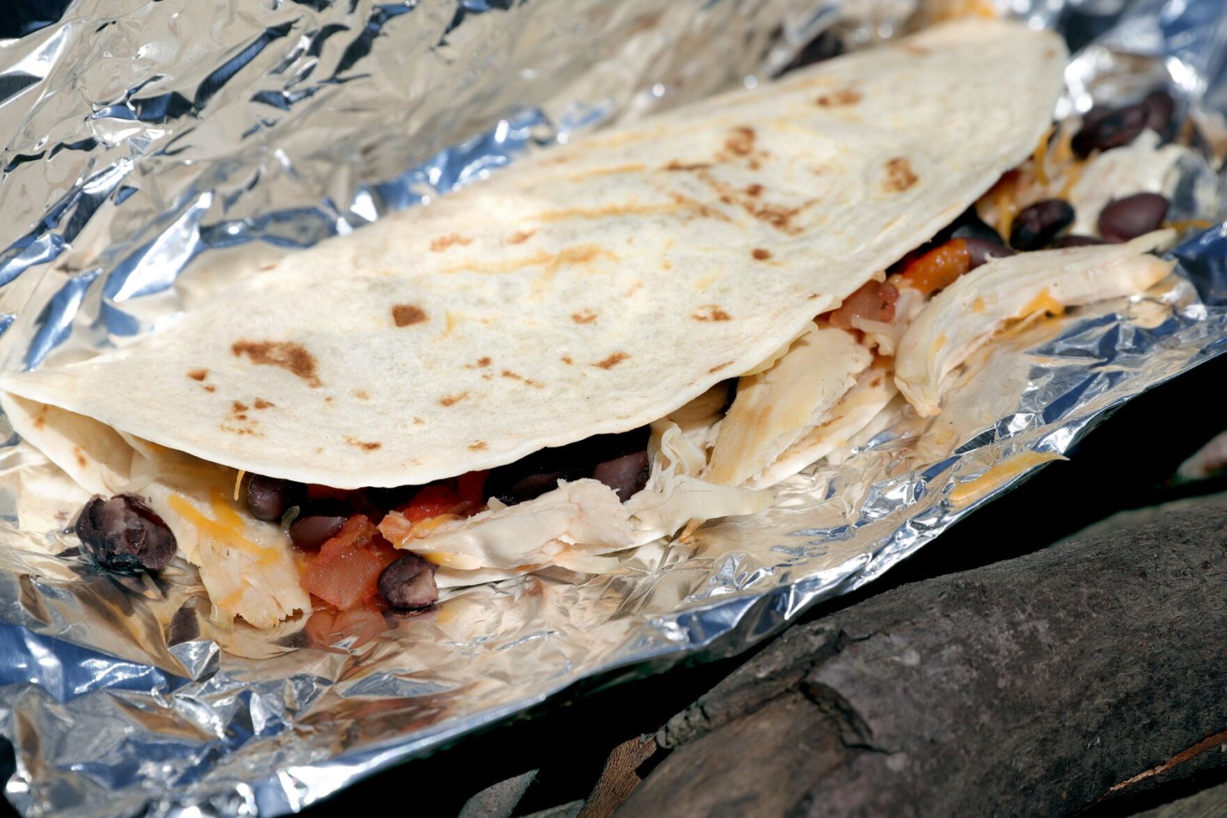 The flames add flavor in campfire cooking